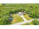 A cozy home surrounded by lush trees; property features a pool, RV, multiple outbuildings, and ample parking at 78 N 5Th St, Orlando, FL 32833