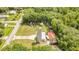 Aerial shot showcasing a cozy home with a pool, outbuildings, and lots of parking spaces surrounded by mature trees at 78 N 5Th St, Orlando, FL 32833