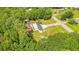 An aerial view captures a home with a pool and several outbuildings on a huge lot filled with lush, mature trees at 78 N 5Th St, Orlando, FL 32833