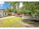 Spacious backyard featuring a trampoline, above-ground pool, wooden deck and shaded structure at 78 N 5Th St, Orlando, FL 32833