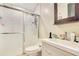 Bathroom featuring a white sink vanity, toilet and a shower with patterned glass doors and chrome trim at 78 N 5Th St, Orlando, FL 32833