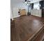 An open bedroom featuring hardwood floors, a high dresser, and a mirror, showing off the spaciousness of the room at 78 N 5Th St, Orlando, FL 32833