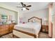Bedroom with a ceiling fan, wood floors, and dresser at 78 N 5Th St, Orlando, FL 32833