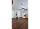 A spacious bedroom featuring hardwood floors, a dresser, and a mirror, showing off the openness of the room at 78 N 5Th St, Orlando, FL 32833
