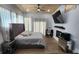 Bedroom boasts wood ceilings, a fireplace, a large upholstered headboard, and a wall mounted TV at 78 N 5Th St, Orlando, FL 32833