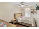 Bright bedroom with a ceiling fan, floral bedding, a wooden bedframe, and decor shelves at 78 N 5Th St, Orlando, FL 32833
