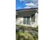 Back exterior view of the house with modern siding, large windows, and a well-manicured lawn at 78 N 5Th St, Orlando, FL 32833