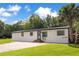 Single-story home with brick driveway, showcasing the home's facade and well-manicured lawn at 78 N 5Th St, Orlando, FL 32833