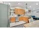 Bright kitchen with stainless steel appliances, wooden cabinets and adjacent to the living area at 78 N 5Th St, Orlando, FL 32833