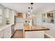 Well-lit kitchen featuring a central island with butcher block countertop, stainless appliances and white cabinets at 78 N 5Th St, Orlando, FL 32833