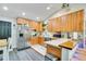 Eat-in kitchen with stainless steel appliances, wooden cabinets, and an island with bar seating at 78 N 5Th St, Orlando, FL 32833