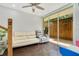 Bright living room with wood floors, ceiling fan, and sliding door access to the outdoors at 78 N 5Th St, Orlando, FL 32833