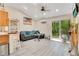 Living room features wood floors, a gray couch, and a sliding glass door with backyard access at 78 N 5Th St, Orlando, FL 32833