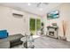 Living room with wood floors, a fireplace, and a sliding glass door to the backyard at 78 N 5Th St, Orlando, FL 32833