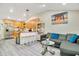 Bright living room with wood floors, open to the kitchen, and featuring a comfortable gray couch at 78 N 5Th St, Orlando, FL 32833