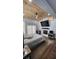 A modern bedroom with a wood ceiling, recessed lighting, a ceiling fan, and a mounted television over a fireplace at 78 N 5Th St, Orlando, FL 32833