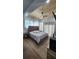 A large bedroom featuring a wood ceiling, a bed with a tufted headboard, and two windows covered with sheer curtains at 78 N 5Th St, Orlando, FL 32833
