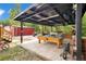 Outdoor entertainment area features a covered patio, pool table, and ample seating with a paver base at 78 N 5Th St, Orlando, FL 32833