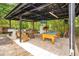 A covered outdoor entertaining area with a pool table, sink, refrigerator, TV, and a table with benches at 78 N 5Th St, Orlando, FL 32833