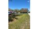 A fenced yard fronts a home with multiple parked vehicles at 78 N 5Th St, Orlando, FL 32833