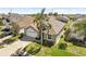 An aerial view of a single-Gathering home showcasing the roof, manicured lawn, driveway, and mature landscaping at 8063 King Palm Cir, Kissimmee, FL 34747