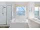 Bathroom featuring a shower, tub and window with natural light at 8063 King Palm Cir, Kissimmee, FL 34747