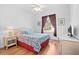 Cozy bedroom with a ceiling fan and a dresser with a TV at 8063 King Palm Cir, Kissimmee, FL 34747