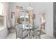 Bright breakfast nook with a glass table and view of the screened-in pool at 8063 King Palm Cir, Kissimmee, FL 34747