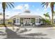 The exterior of the clubhouse, featuring an octagonal roof and decorative palm trees at 8063 King Palm Cir, Kissimmee, FL 34747