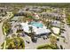 Aerial view of community center pool, tennis courts, and ample parking at 8063 King Palm Cir, Kissimmee, FL 34747