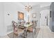 Formal dining room with decorative chandelier and seating for four featuring a glass-topped table at 8063 King Palm Cir, Kissimmee, FL 34747