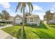 Charming single-Gathering home with a manicured lawn, mature palm trees, and beautiful landscaping at 8063 King Palm Cir, Kissimmee, FL 34747