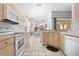 Bright kitchen with white appliances and lots of natural light looking out onto the outdoor pool area at 8063 King Palm Cir, Kissimmee, FL 34747