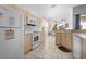 Kitchen with white appliances, light wood cabinets, and breakfast nook bathed in natural light at 8063 King Palm Cir, Kissimmee, FL 34747