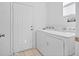 Laundry area with a washer and dryer set, with access to an exterior door at 8063 King Palm Cir, Kissimmee, FL 34747