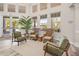 A bright lobby area with several chairs, a large potted plant, and a wall of windows at 8063 King Palm Cir, Kissimmee, FL 34747