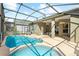 Outdoor screened-in pool area features both a swimming pool and hot tub, with ample lounging space at 8063 King Palm Cir, Kissimmee, FL 34747
