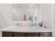 Bright bathroom featuring double sinks, a large mirror, and tile flooring at 817 Bocavista Ct, Davenport, FL 33896