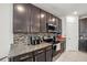 Close-up of a kitchen with granite countertops, stainless steel appliances, and a decorative backsplash at 817 Bocavista Ct, Davenport, FL 33896