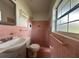 Retro bathroom with a tile shower, single sink vanity, and classic charm at 8212 Le Mesa St, Orlando, FL 32827
