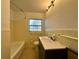 This bathroom has a vanity, toilet, bathtub and tiled walls at 8212 Le Mesa St, Orlando, FL 32827