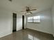 This bedroom features a ceiling fan, window, closet and carpeted floors at 8212 Le Mesa St, Orlando, FL 32827