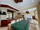 Clubhouse bar area with barstool seating, a kitchenette, and views of the lounge and game room at 8300 Elm Park Dr # 7110, Orlando, FL 32821