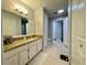 Well-lit bathroom featuring tiled floors, a granite vanity, and ample cabinet space at 8300 Elm Park Dr # 7110, Orlando, FL 32821