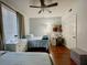 Bedroom with twin beds, a ceiling fan, and a desk, designed for comfort and productivity at 8300 Elm Park Dr # 7110, Orlando, FL 32821