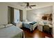 Cozy bedroom with two twin beds, hardwood floors, and a ceiling fan at 8300 Elm Park Dr # 7110, Orlando, FL 32821