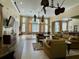 Spacious clubhouse lounge area with comfortable seating, large windows, and elegant ceiling fans at 8300 Elm Park Dr # 7110, Orlando, FL 32821