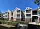 Condominium exterior featuring multiple levels and screened-in balconies on a sunny day at 8300 Elm Park Dr # 7110, Orlando, FL 32821
