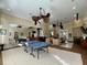 Open game room with a ping pong table, pool table, seating areas, and a bar for entertaining at 8300 Elm Park Dr # 7110, Orlando, FL 32821