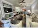 Open-concept living room with a modern design, including a sofa, chairs, and entertainment center at 8300 Elm Park Dr # 7110, Orlando, FL 32821